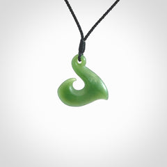 New Zealand jade hei-mate pendant. Hand carved in bright green jade by Ric Moor. The pendant is suspended from a black plaited cord and is finished in a satin matte polish.