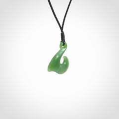 New Zealand jade hei-mate pendant. Hand carved in bright green jade by Ric Moor. The pendant is suspended from a black plaited cord and is finished in a satin matte polish.