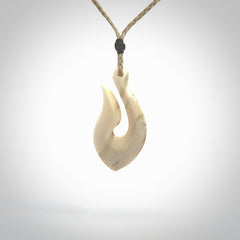 Hand carved ancient woolly mammoth tusk hook necklace with adjustable cord. Mammoth Tusk stabilised with blue resin pendant. Unique medium sized hook necklaces hand made from woolly mammoth tusk. Real ancient mammoth tusk delivered in a woven kete pouch.