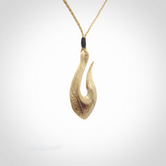 Hand carved ancient woolly mammoth tusk hook necklace with adjustable cord. Mammoth Tusk stabilised with blue resin pendant. Unique medium sized hook necklaces hand made from woolly mammoth tusk. Real ancient mammoth tusk delivered in a woven kete pouch.