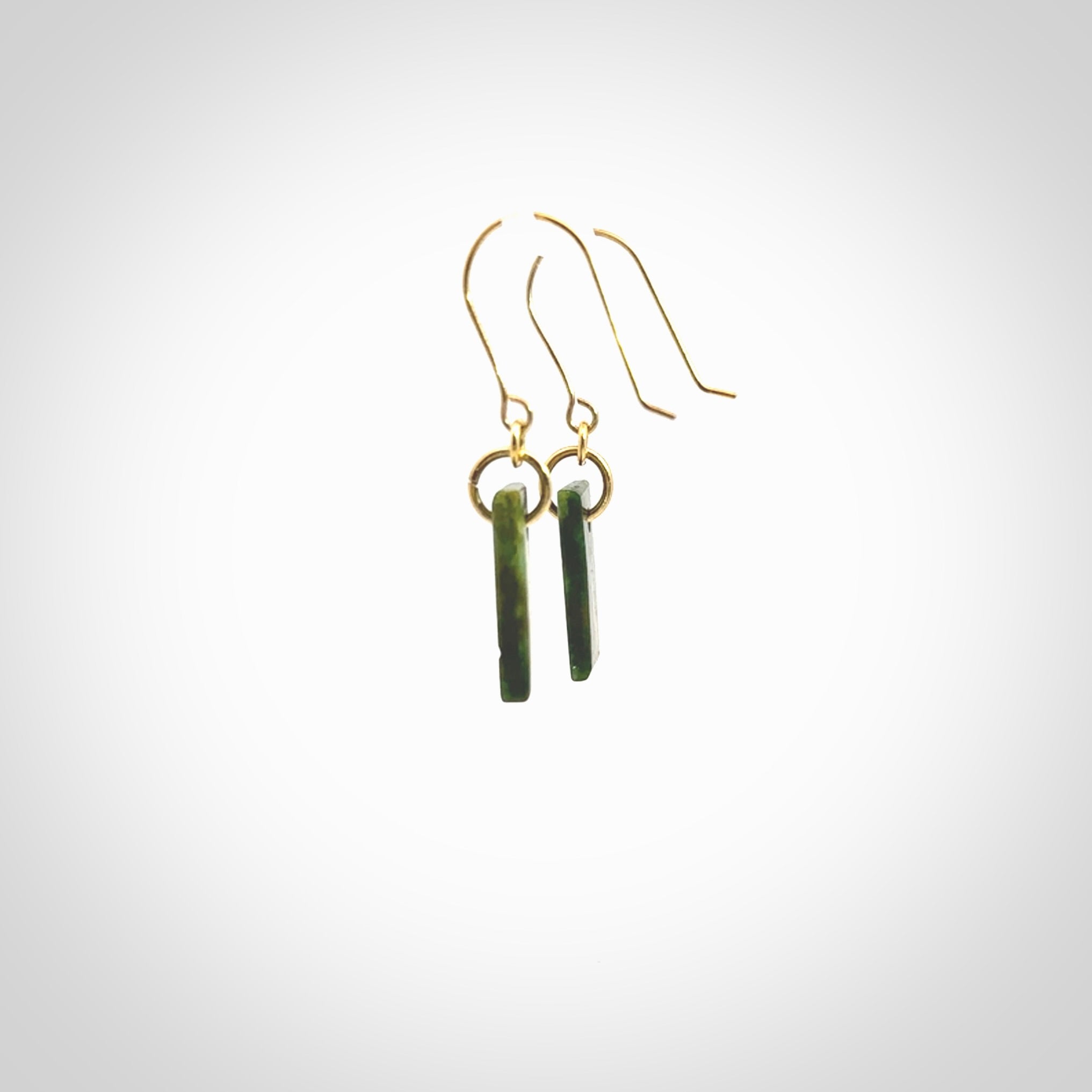 These small drop earrings are beautifully hand made with gorgeous flair. They are fashionable and perfect for a women with style. Hand carved from a gorgeous piece of New Zealand Marsden jade with Gold leaf and gold plated hooks - they are elegant and beautiful.