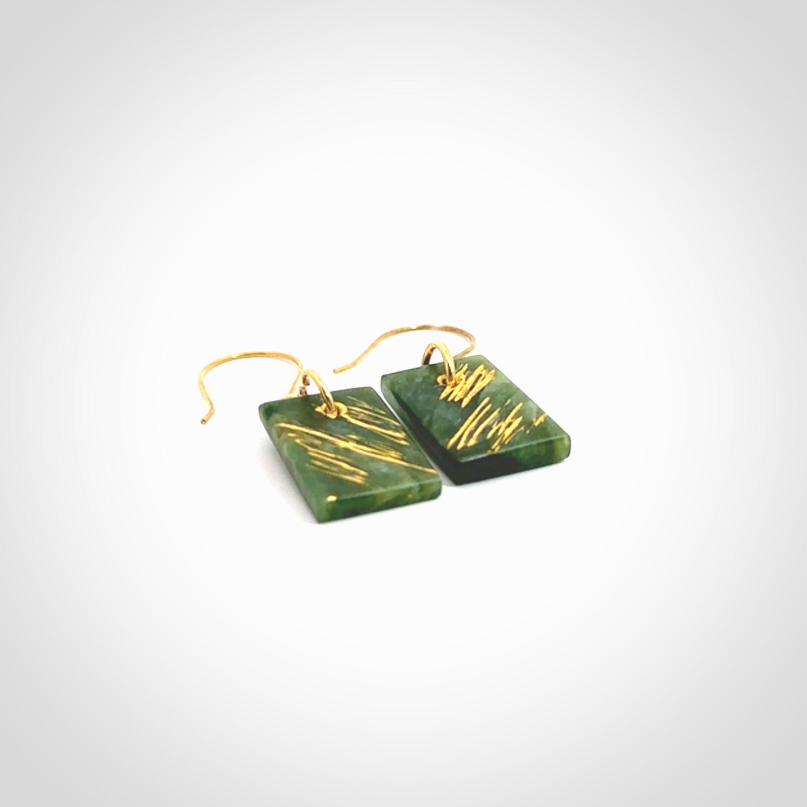 These drop earrings are beautifully hand made with gorgeous flair. They are fashionable and perfect for a woman with style. Hand carved from a gorgeous piece of New Zealand Marsden jade with Gold leaf and gold plated hooks - they are elegant and beautiful.