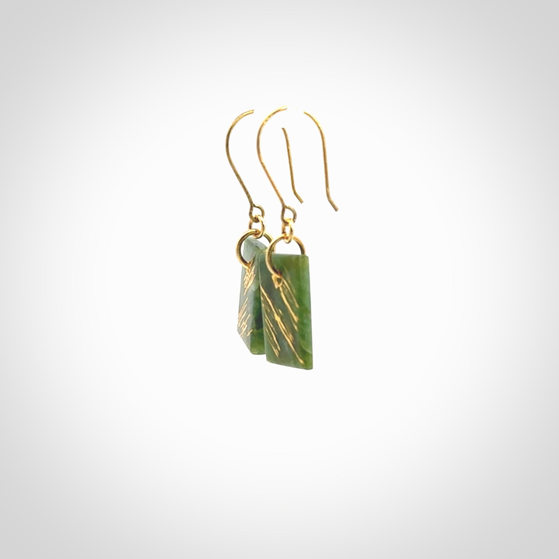 These drop earrings are beautifully hand made with gorgeous flair. They are fashionable and perfect for a woman with style. Hand carved from a gorgeous piece of New Zealand Marsden jade with Gold leaf and gold plated hooks - they are elegant and beautiful.