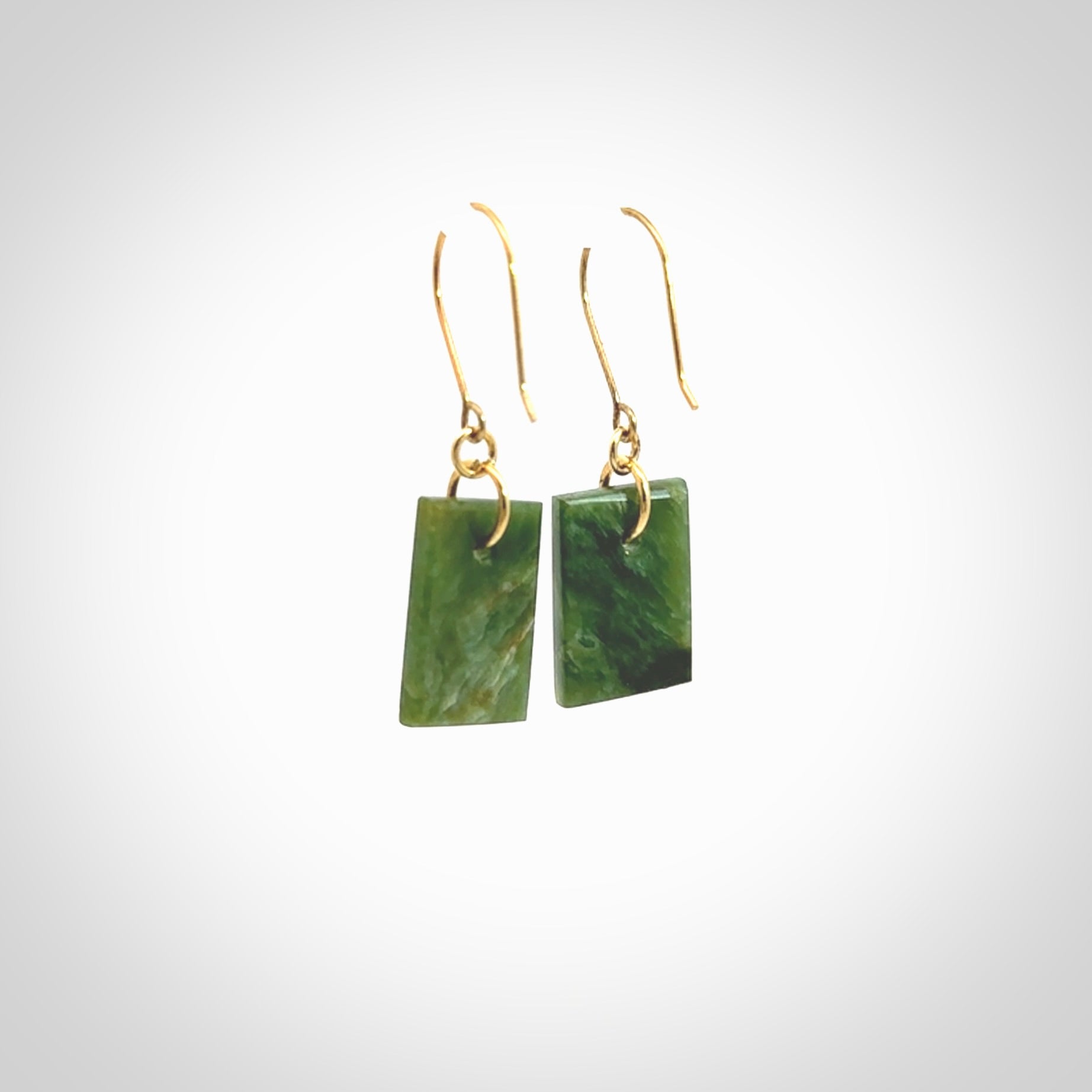 These drop earrings are beautifully hand made with gorgeous flair. They are fashionable and perfect for a woman with style. Hand carved from a gorgeous piece of New Zealand Marsden jade with Gold leaf and gold plated hooks - they are elegant and beautiful.