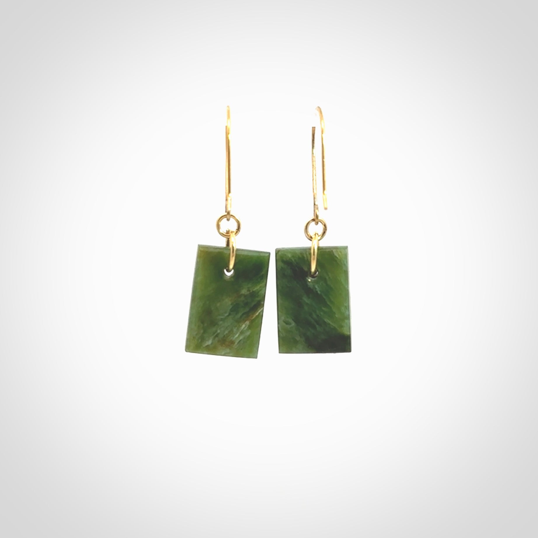 These drop earrings are beautifully hand made with gorgeous flair. They are fashionable and perfect for a woman with style. Hand carved from a gorgeous piece of New Zealand Marsden jade with Gold leaf and gold plated hooks - they are elegant and beautiful.