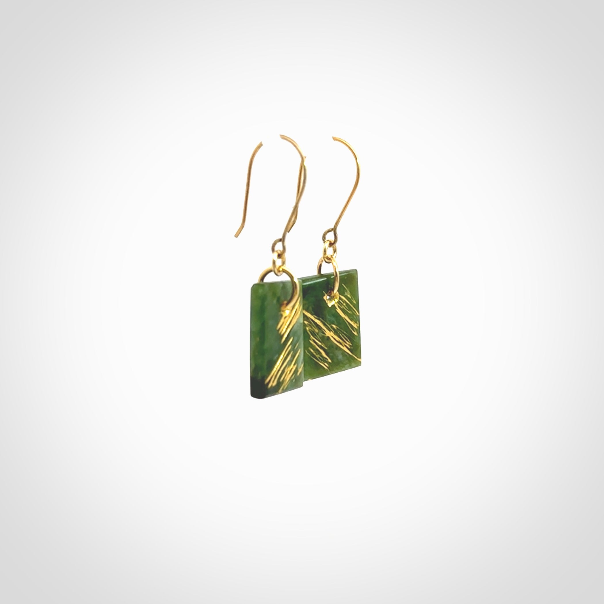 These drop earrings are beautifully hand made with gorgeous flair. They are fashionable and perfect for a woman with style. Hand carved from a gorgeous piece of New Zealand Marsden jade with Gold leaf and gold plated hooks - they are elegant and beautiful.