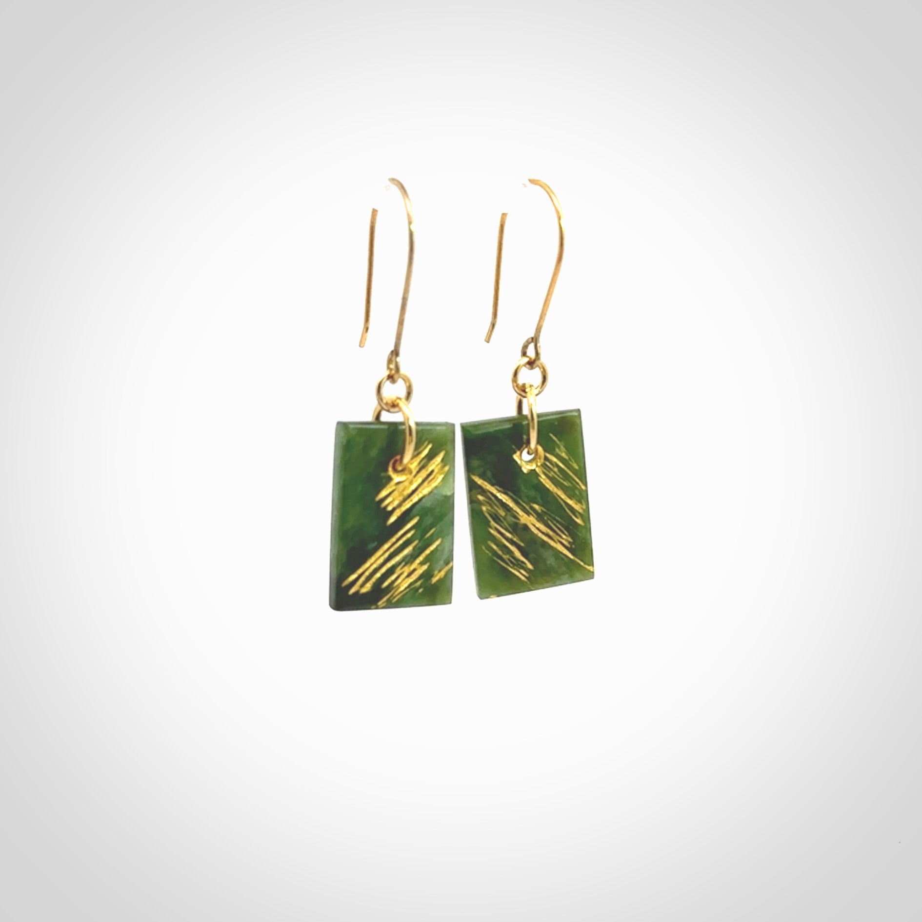 These drop earrings are beautifully hand made with gorgeous flair. They are fashionable and perfect for a woman with style. Hand carved from a gorgeous piece of New Zealand Marsden jade with Gold leaf and gold plated hooks - they are elegant and beautiful.