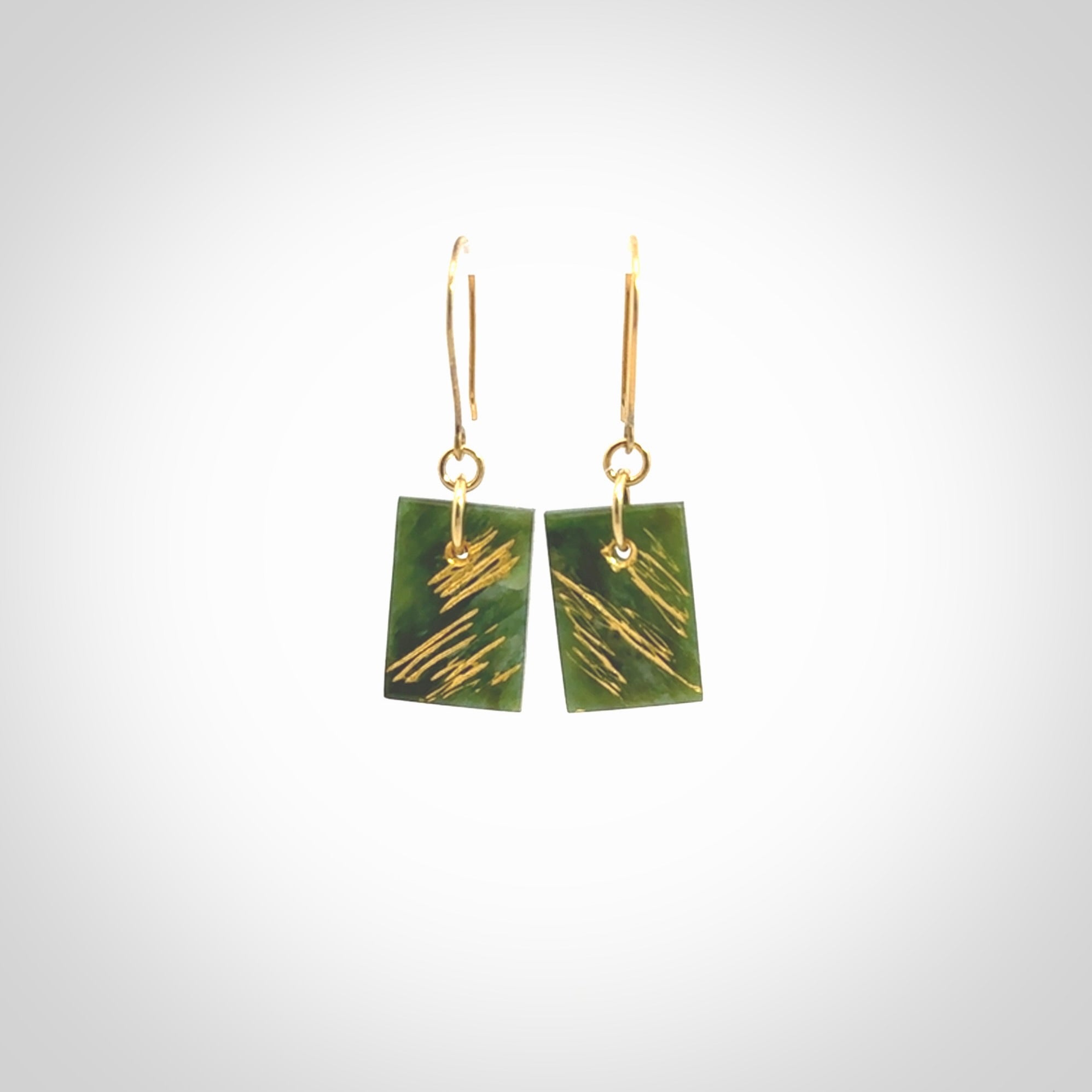 These drop earrings are beautifully hand made with gorgeous flair. They are fashionable and perfect for a woman with style. Hand carved from a gorgeous piece of New Zealand Marsden jade with Gold leaf and gold plated hooks - they are elegant and beautiful.