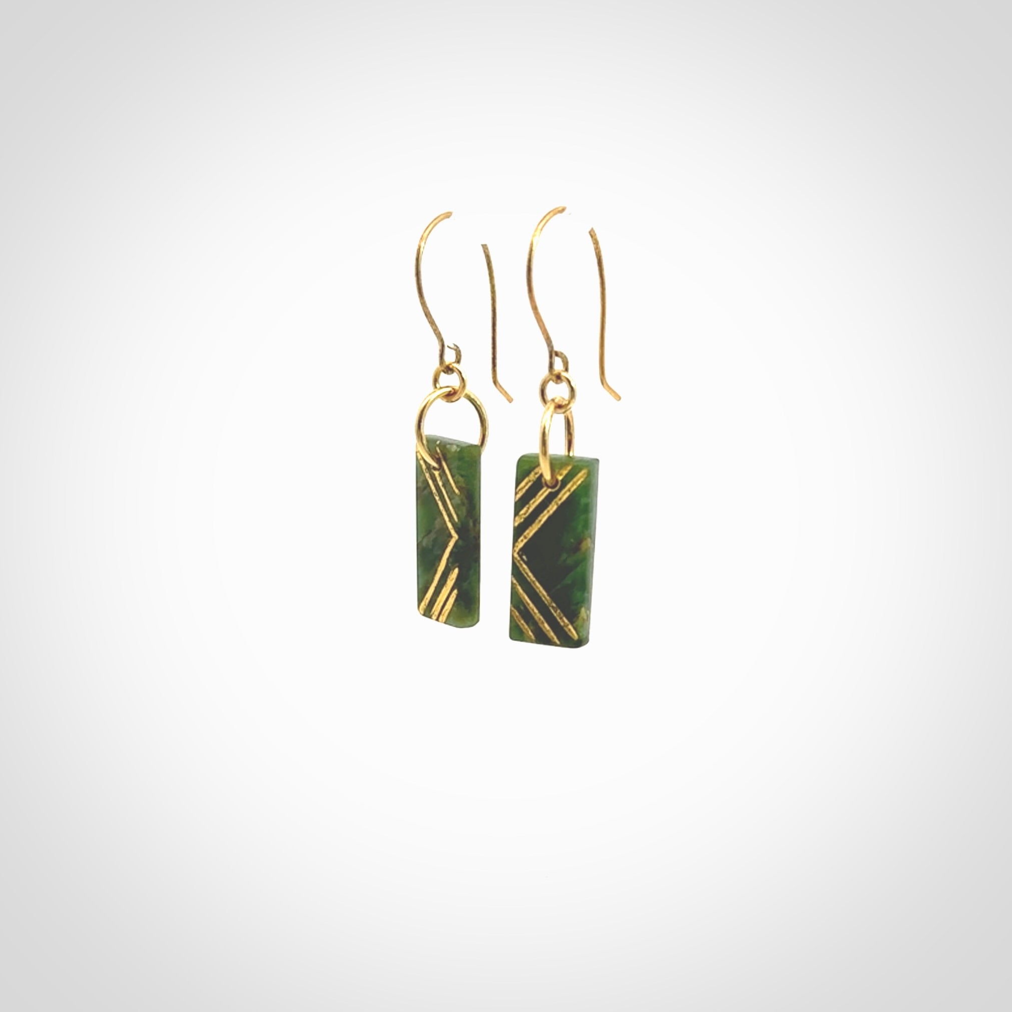 These drop earrings are beautifully hand made with gorgeous flair. They are fashionable and perfect for a woman with style. Hand carved from a gorgeous piece of New Zealand Marsden jade with Gold leaf and gold plated hooks - they are elegant and beautiful.