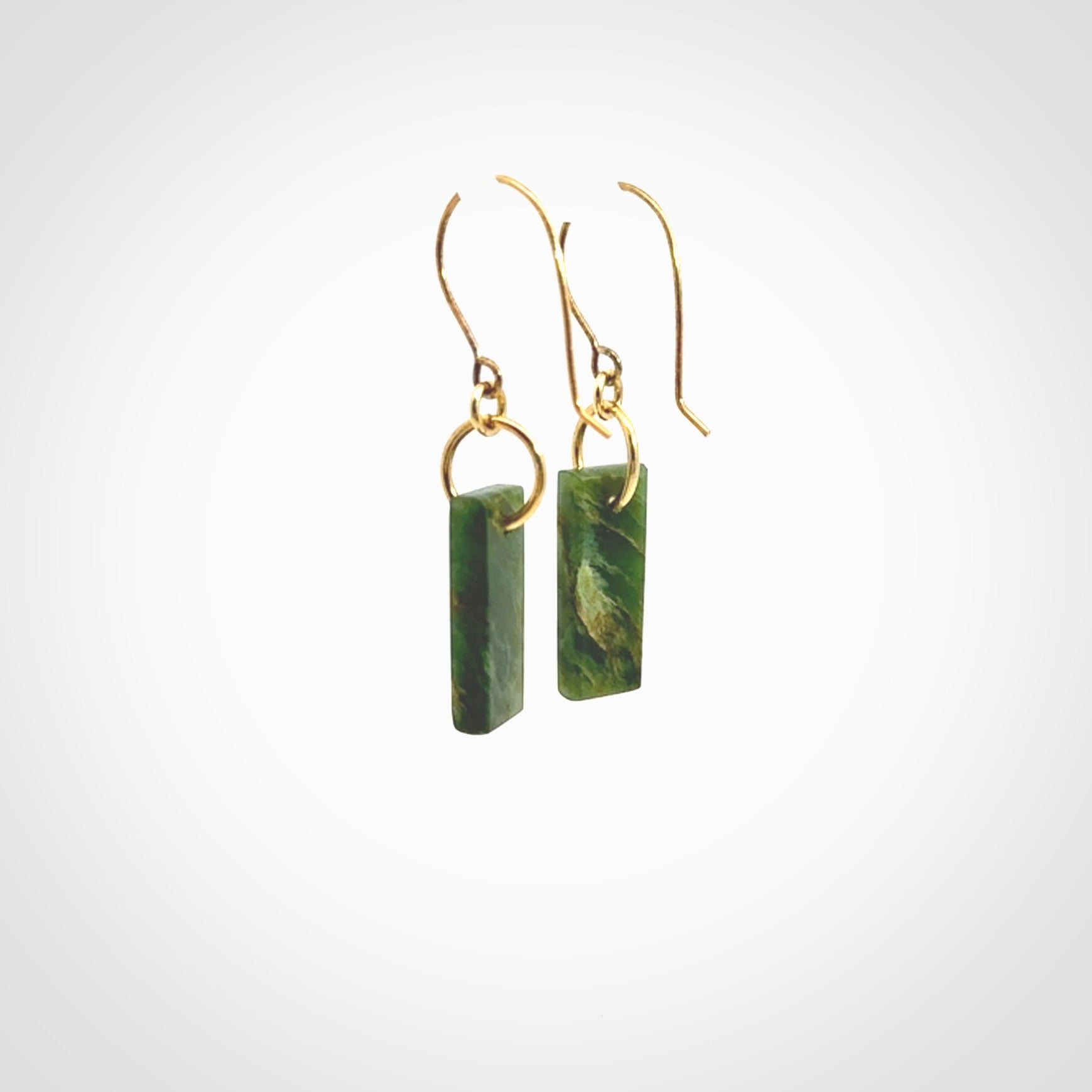 These drop earrings are beautifully hand made with gorgeous flair. They are fashionable and perfect for a woman with style. Hand carved from a gorgeous piece of New Zealand Marsden jade with Gold leaf and gold plated hooks - they are elegant and beautiful.