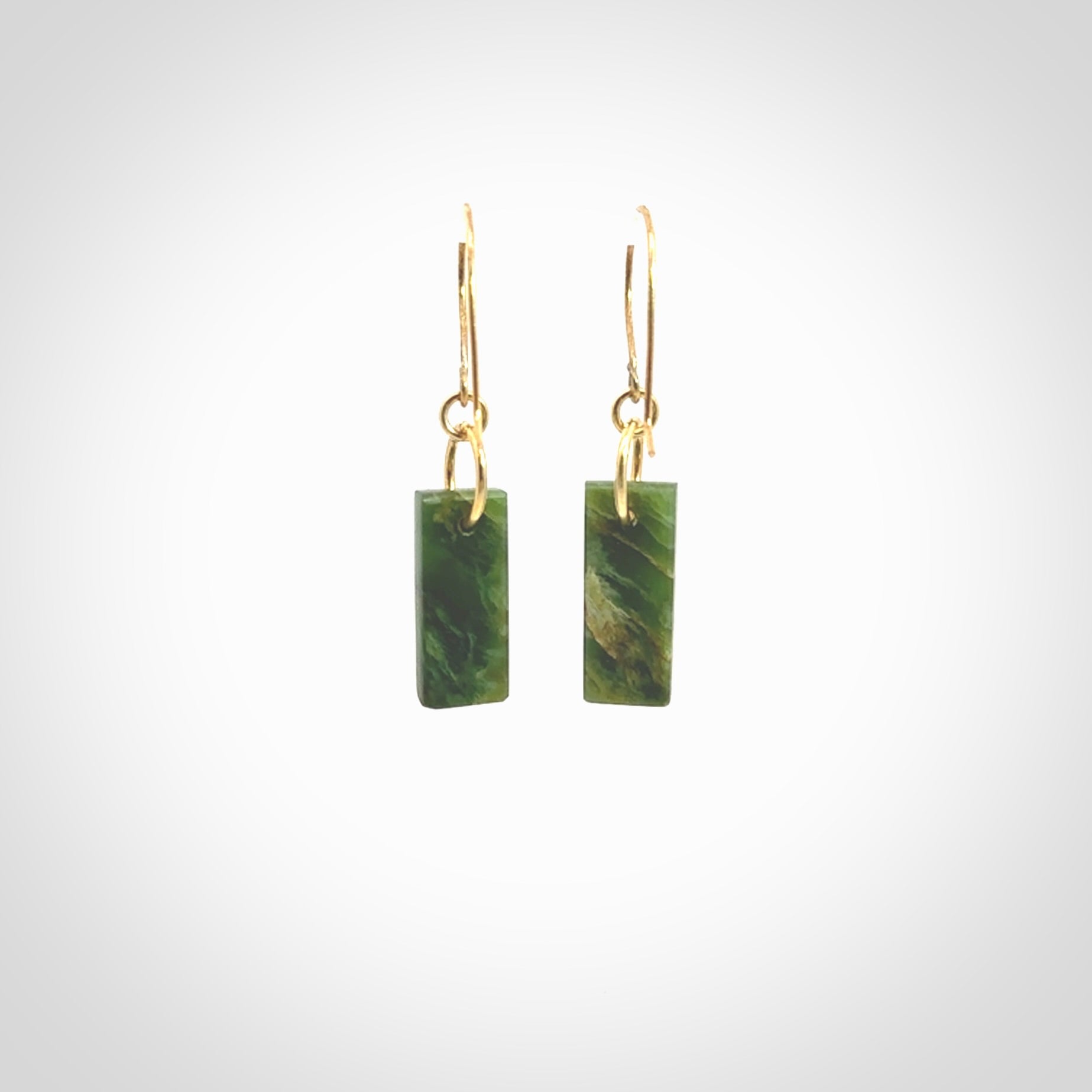 These drop earrings are beautifully hand made with gorgeous flair. They are fashionable and perfect for a woman with style. Hand carved from a gorgeous piece of New Zealand Marsden jade with Gold leaf and gold plated hooks - they are elegant and beautiful.