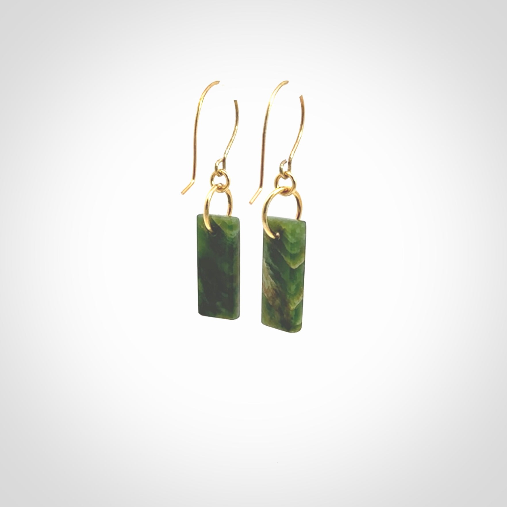 These drop earrings are beautifully hand made with gorgeous flair. They are fashionable and perfect for a woman with style. Hand carved from a gorgeous piece of New Zealand Marsden jade with Gold leaf and gold plated hooks - they are elegant and beautiful.