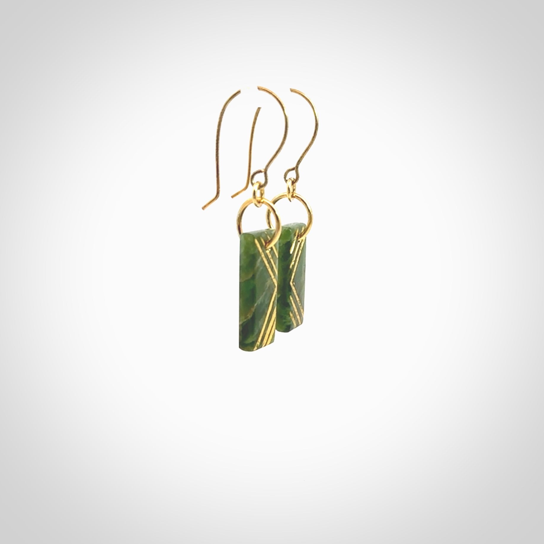 These drop earrings are beautifully hand made with gorgeous flair. They are fashionable and perfect for a woman with style. Hand carved from a gorgeous piece of New Zealand Marsden jade with Gold leaf and gold plated hooks - they are elegant and beautiful.