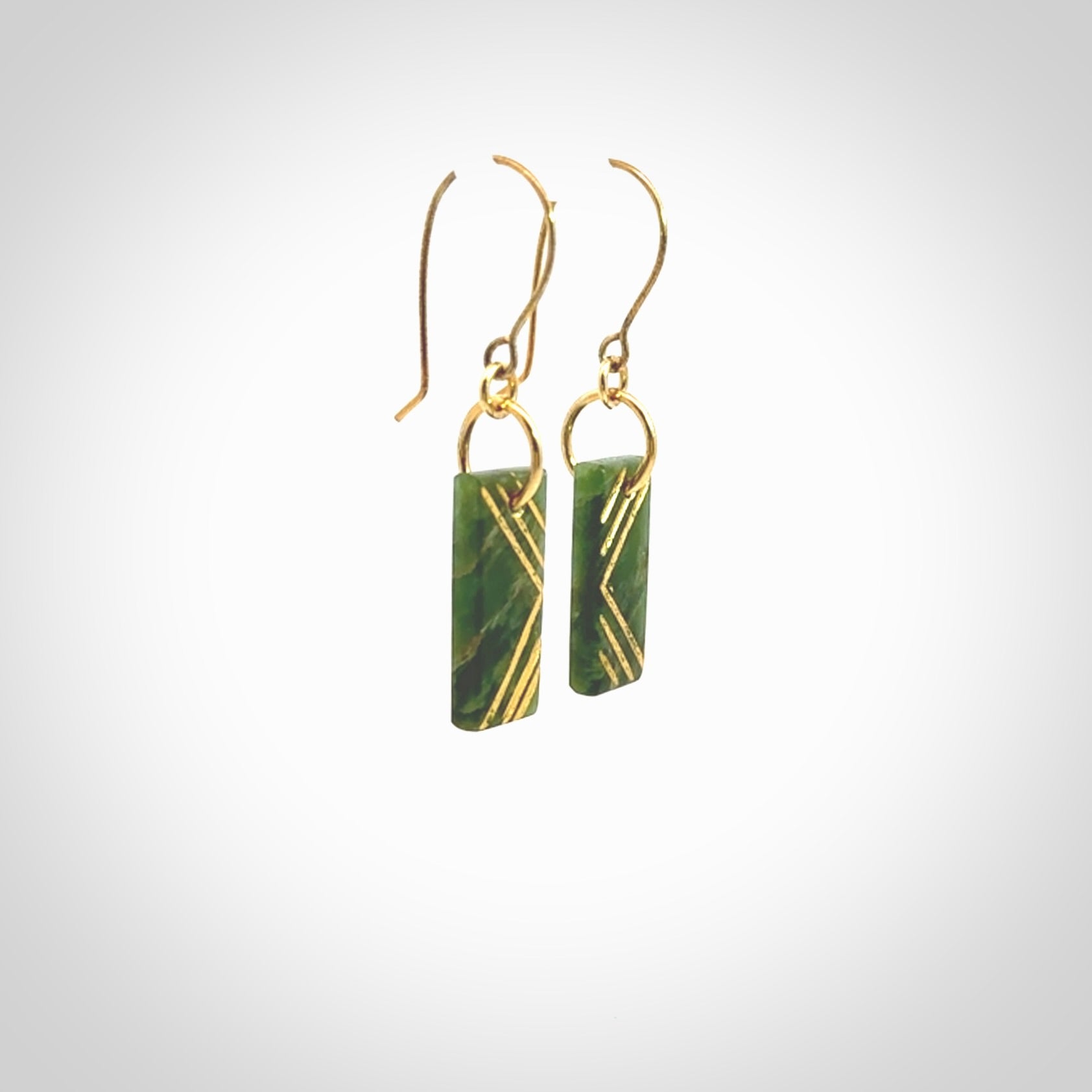 These drop earrings are beautifully hand made with gorgeous flair. They are fashionable and perfect for a woman with style. Hand carved from a gorgeous piece of New Zealand Marsden jade with Gold leaf and gold plated hooks - they are elegant and beautiful.