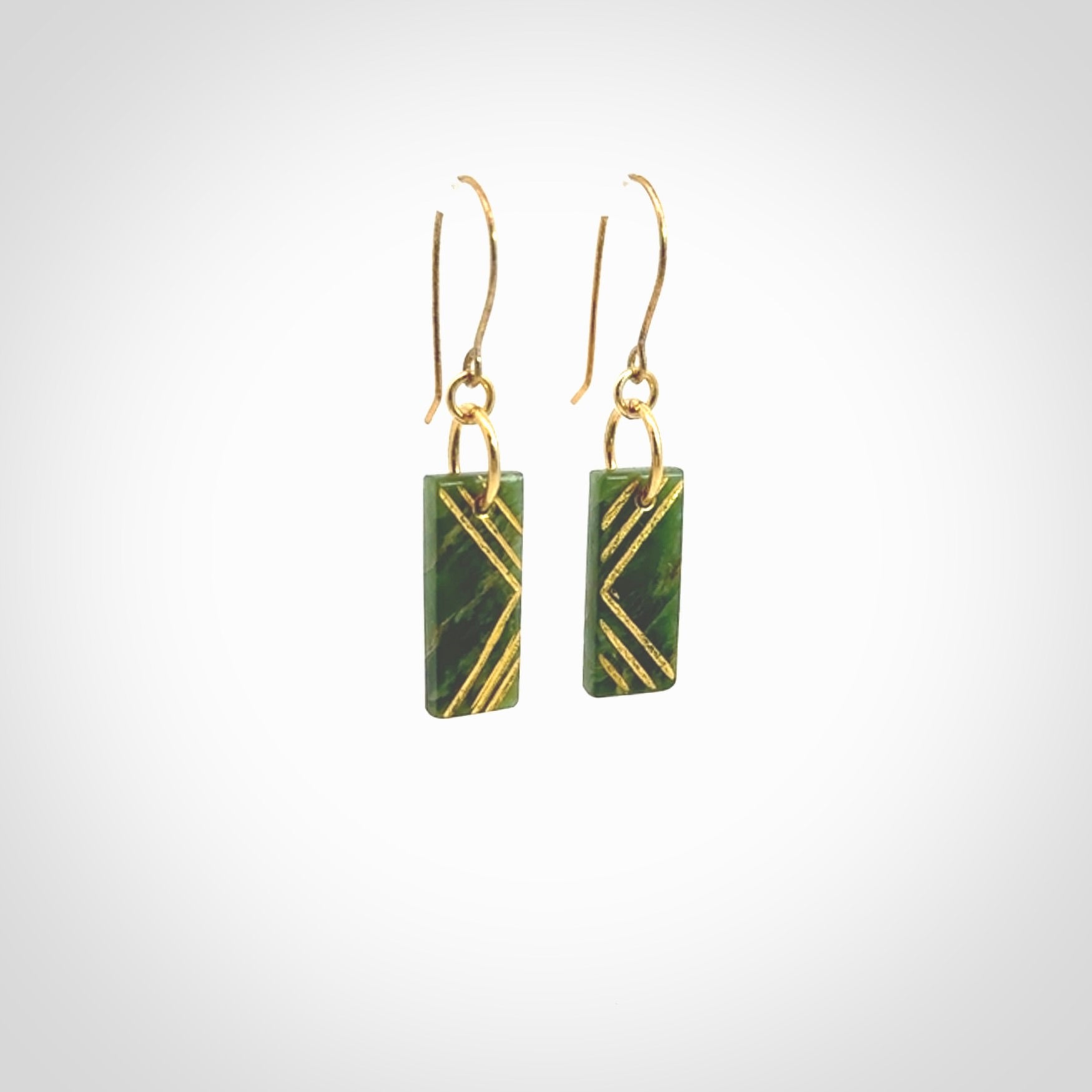 These drop earrings are beautifully hand made with gorgeous flair. They are fashionable and perfect for a woman with style. Hand carved from a gorgeous piece of New Zealand Marsden jade with Gold leaf and gold plated hooks - they are elegant and beautiful.