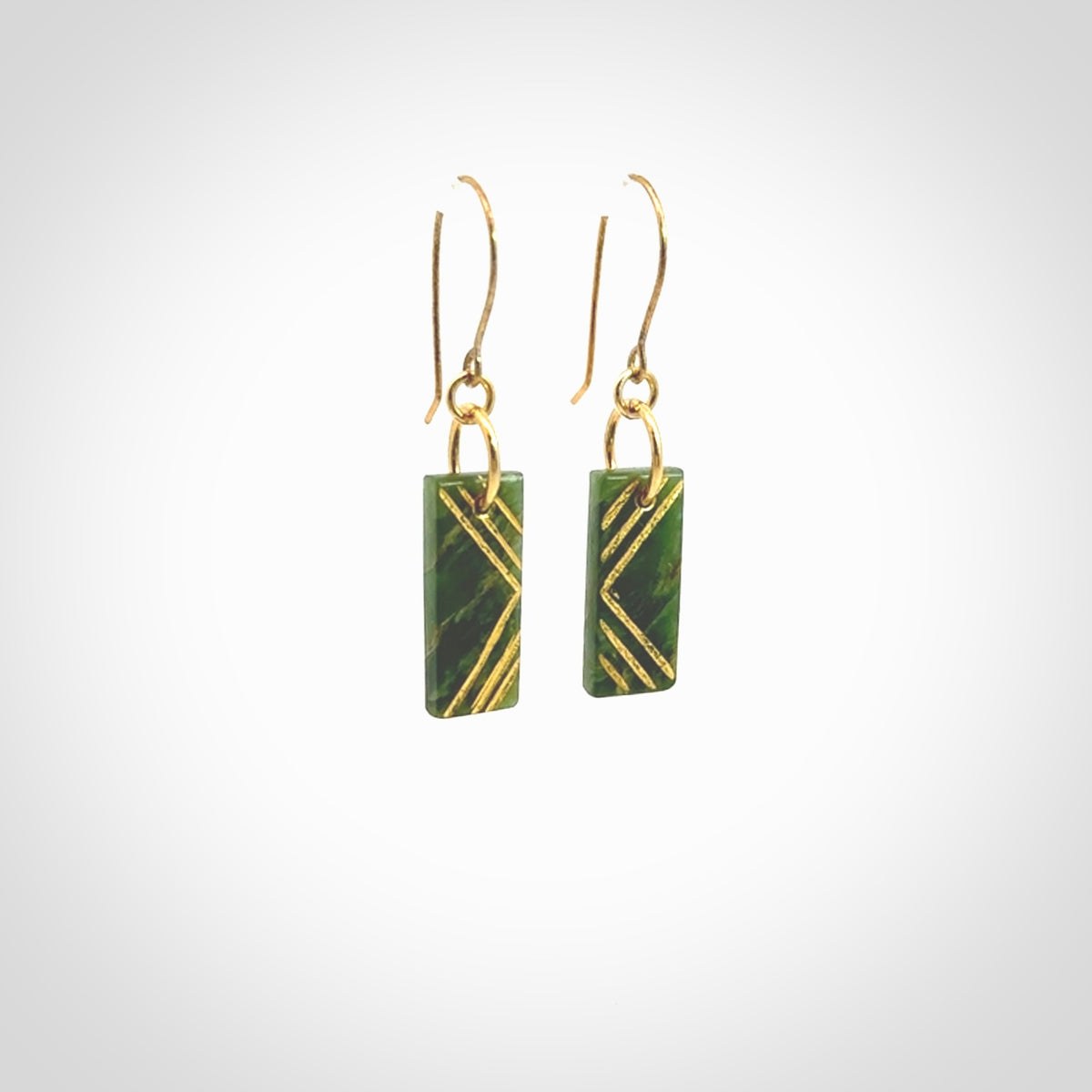 These drop earrings are beautifully hand made with gorgeous flair. They are fashionable and perfect for a woman with style. Hand carved from a gorgeous piece of New Zealand Marsden jade with Gold leaf and gold plated hooks - they are elegant and beautiful.