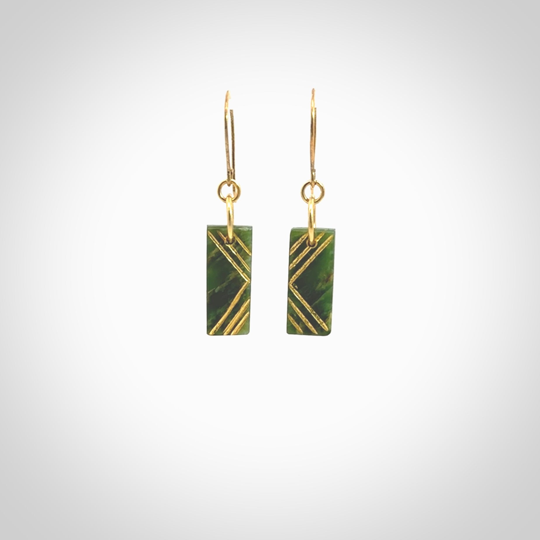 These drop earrings are beautifully hand made with gorgeous flair. They are fashionable and perfect for a woman with style. Hand carved from a gorgeous piece of New Zealand Marsden jade with Gold leaf and gold plated hooks - they are elegant and beautiful.