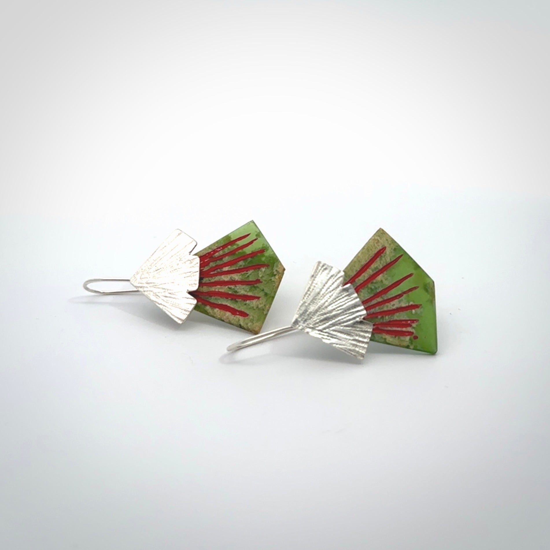 Hand made New Zealand Jade Rata drop earrings with sterling silver and red enamel. Hand crafted by Ana Krakosky. Beautiful Jade earrings hand made in New Zealand. One pair only. Provided in a woven kete pouch.