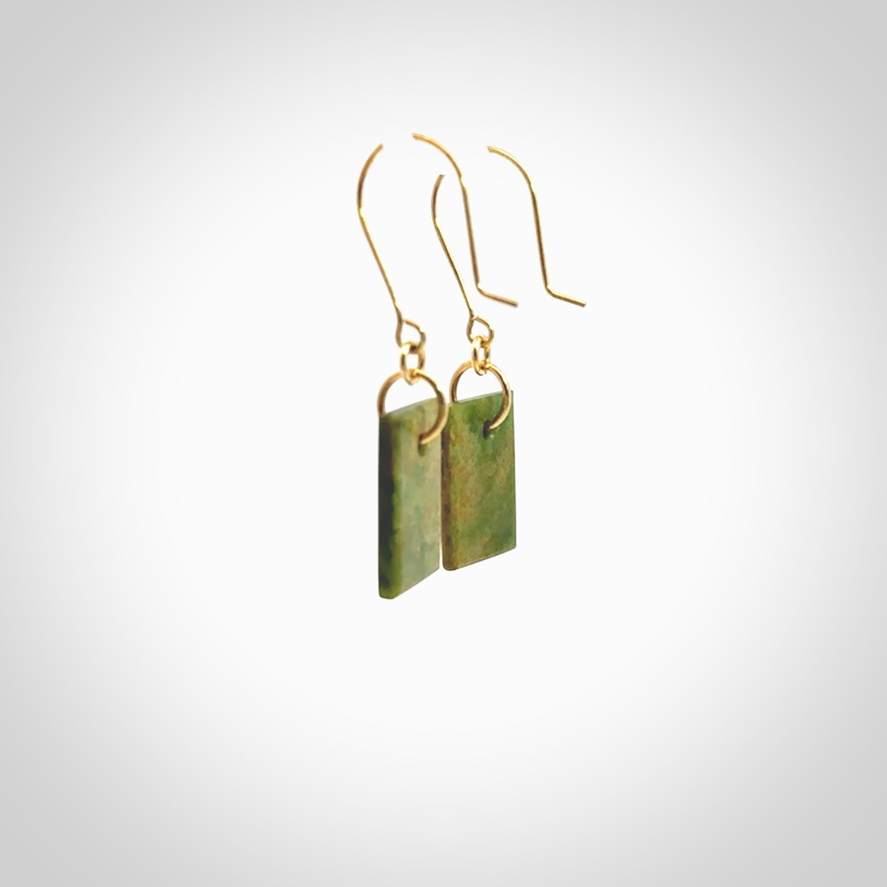 These earrings are beautifully hand made in New Zealand Jade with Gold Enamel. They have koru designs are are gorgeous. They are fashionable and perfect for a women with style. Hand carved from a gorgeous piece of New Zealand Marsden jade with Gold leaf and gold plated hooks - they are elegant and beautiful.