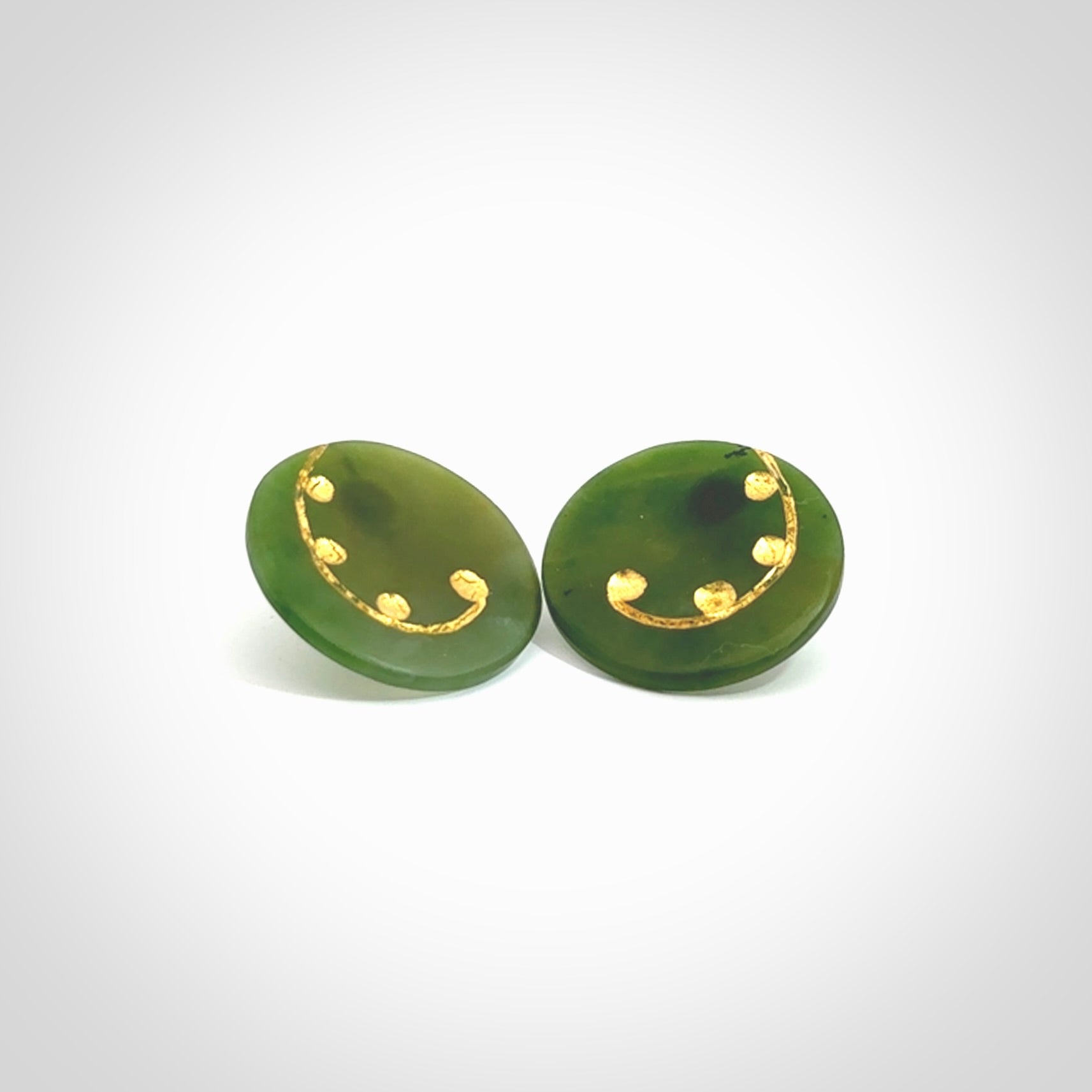 These large round stud earrings are beautifully hand made in New Zealand Jade with Gold Leaf Enamel. They have koru designs are are gorgeous. They are fashionable and perfect for a women with style. Hand carved from a gorgeous piece of New Zealand Marsden jade with Gold leaf and gold plated studs - they are elegant and beautiful.