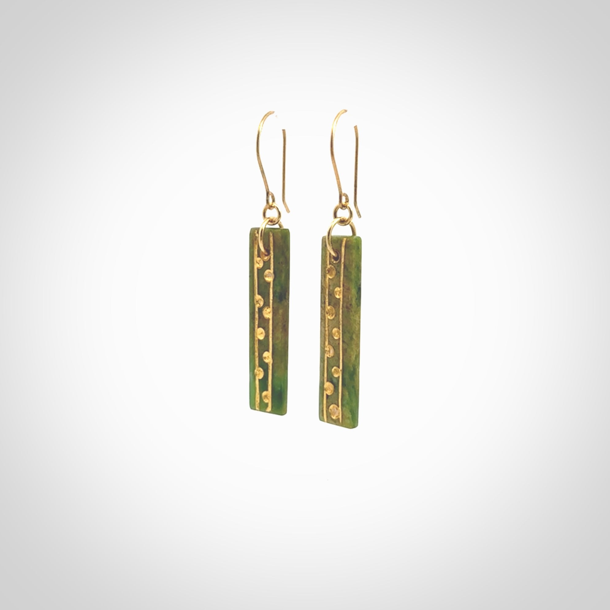 These large drop earrings are beautifully hand made with gorgeous flair. They are fashionable and perfect for a women with style. Hand carved from a gorgeous piece of New Zealand Marsden jade with Gold leaf and gold plated hooks - they are elegant and beautiful.