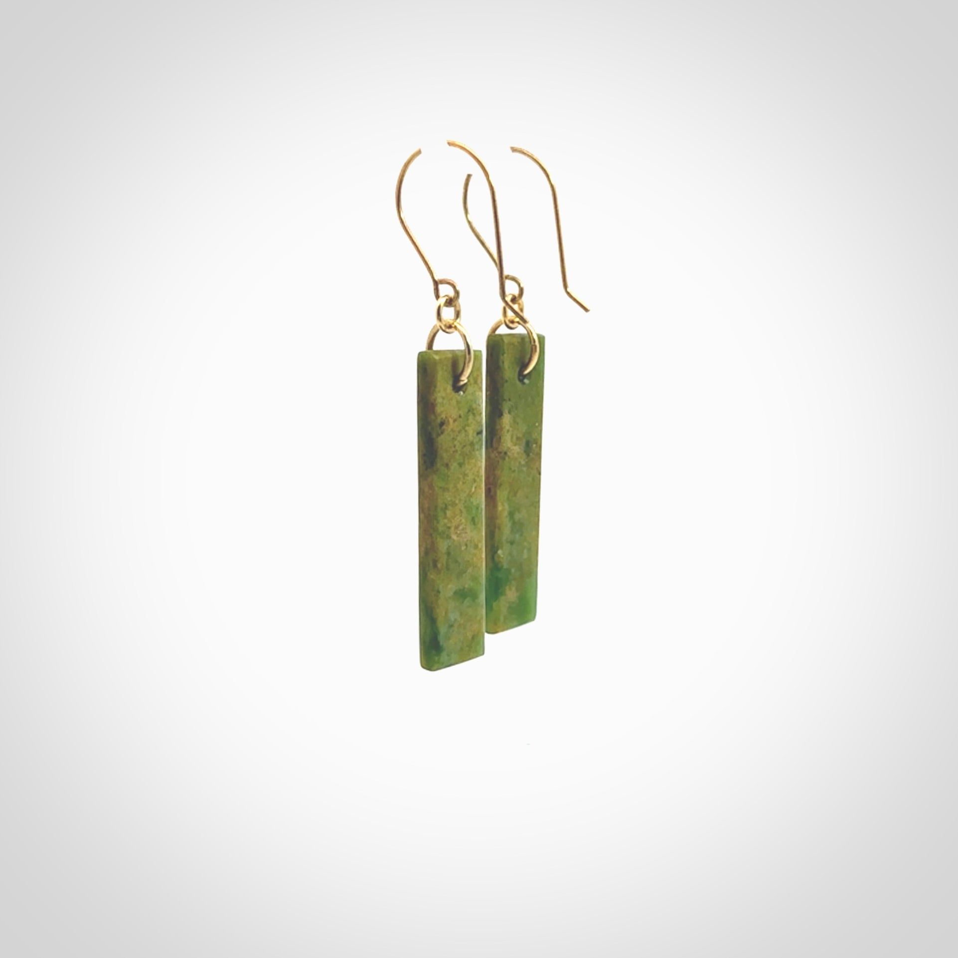 These large drop earrings are beautifully hand made with gorgeous flair. They are fashionable and perfect for a women with style. Hand carved from a gorgeous piece of New Zealand Marsden jade with Gold leaf and gold plated hooks - they are elegant and beautiful.