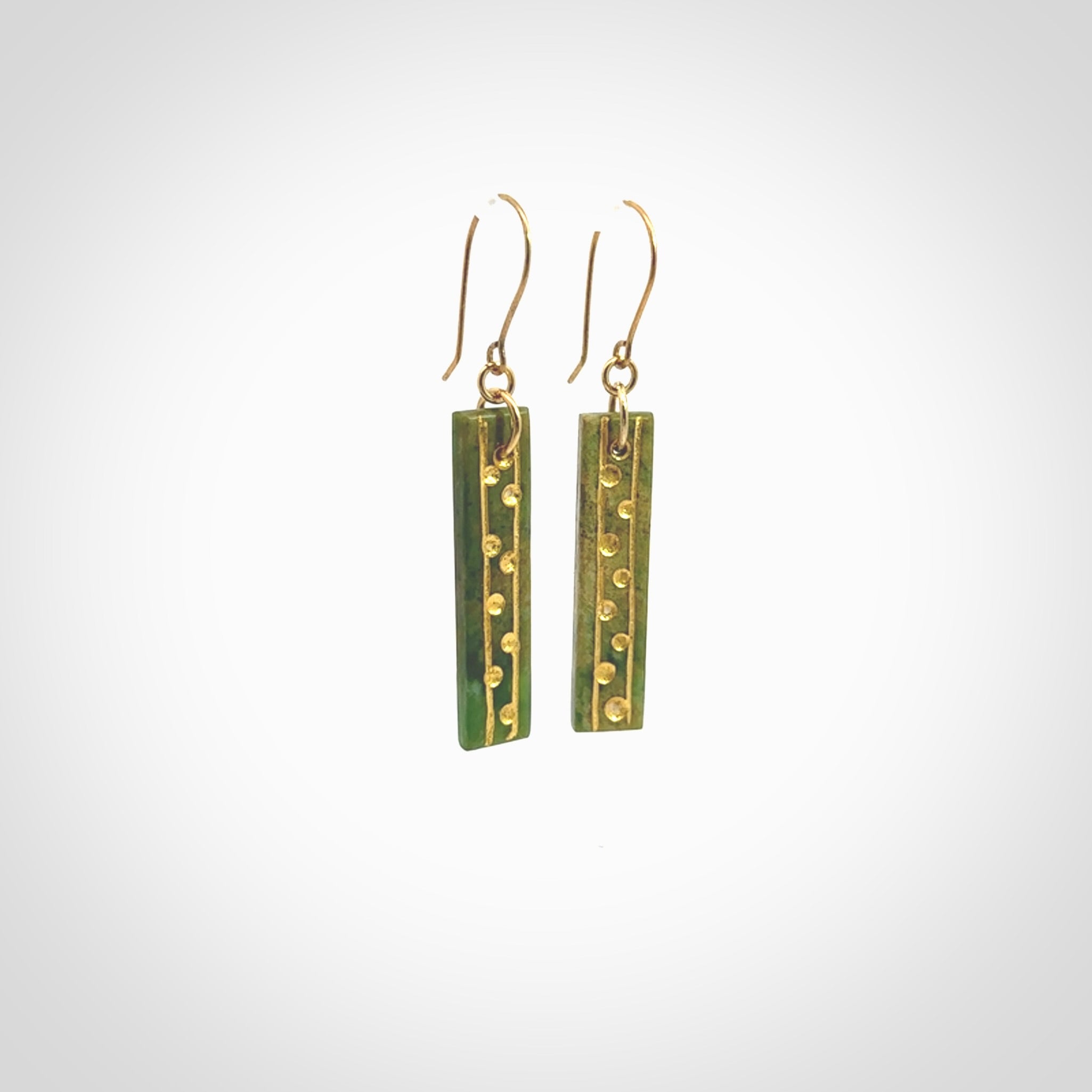 These large drop earrings are beautifully hand made with gorgeous flair. They are fashionable and perfect for a women with style. Hand carved from a gorgeous piece of New Zealand Marsden jade with Gold leaf and gold plated hooks - they are elegant and beautiful.