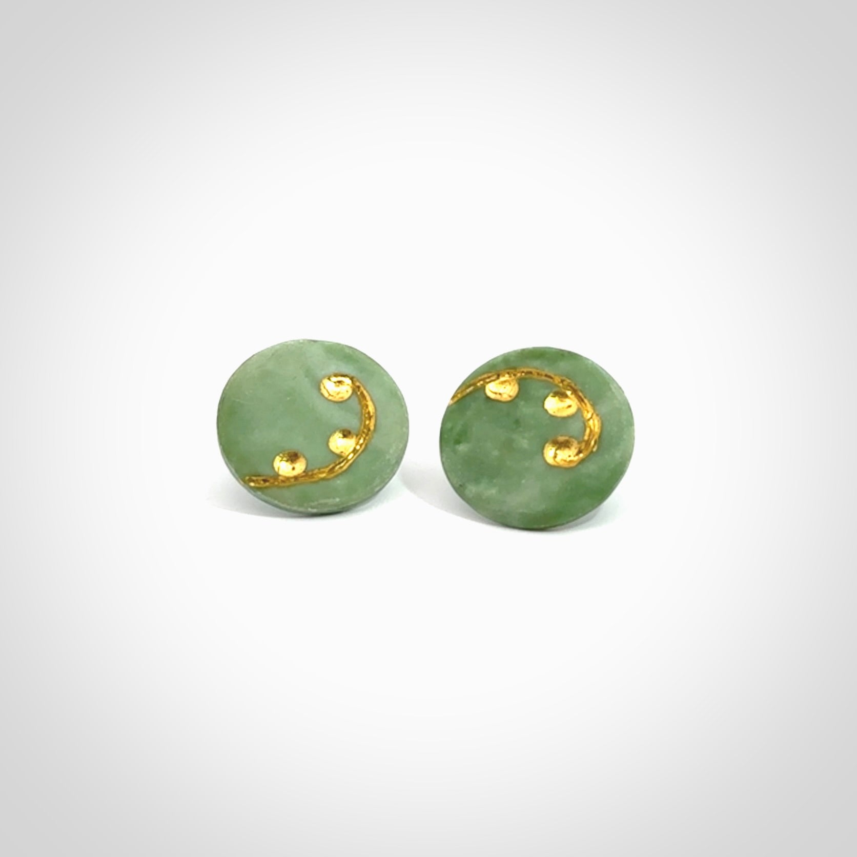 These round stud earrings are beautifully hand made in New Zealand Jade with Gold Leaf Enamel. They have fern leaf designs are are gorgeous. They are fashionable and perfect for a women with style. Hand carved from a gorgeous piece of New Zealand jade with Gold leaf and gold plated studs - they are elegant and beautiful.