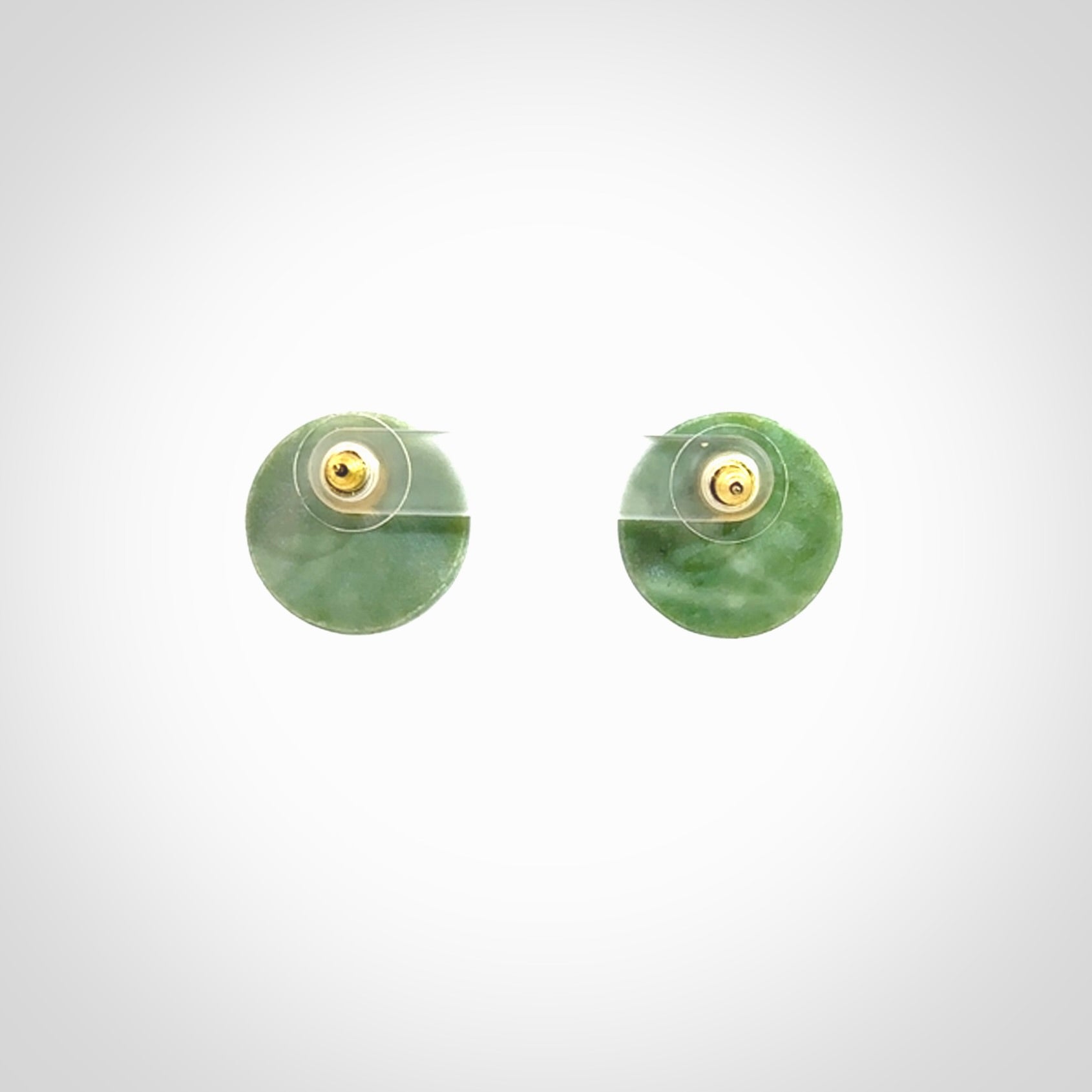 These round stud earrings are beautifully hand made in New Zealand Jade with Gold Leaf Enamel. They have fern leaf designs are are gorgeous. They are fashionable and perfect for a women with style. Hand carved from a gorgeous piece of New Zealand jade with Gold leaf and gold plated studs - they are elegant and beautiful.