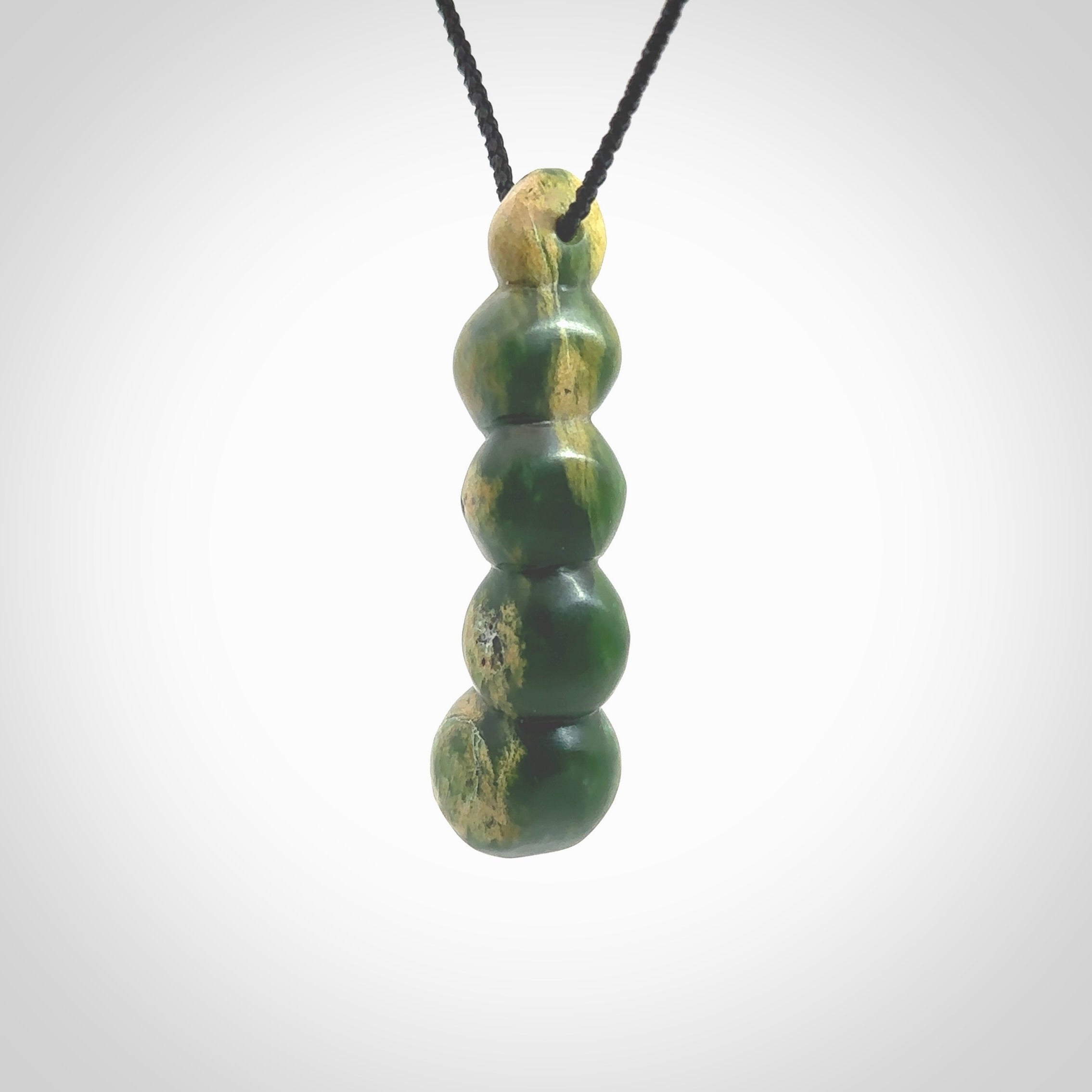 Hand carved New Zealand flower Jade beads drop pendant. Made by Ana Krakosky for NZ Pacific in New Zealand Pounamu, jade. A beautiful orange and green jade beads necklace with black adjustable cord. Large beads necklace carved in flower Jade.