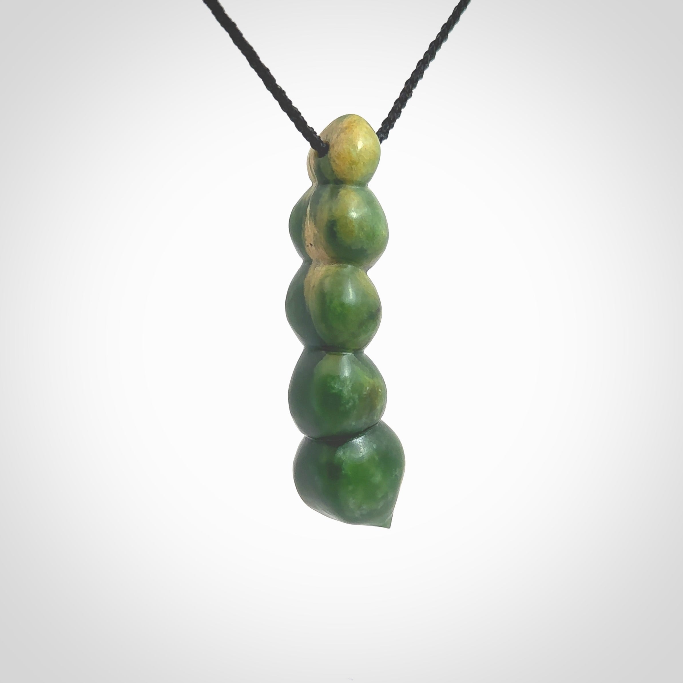 Hand carved New Zealand flower Jade beads drop pendant. Made by Ana Krakosky for NZ Pacific in New Zealand Pounamu, jade. A beautiful orange and green jade beads necklace with black adjustable cord. Large beads necklace carved in flower Jade.