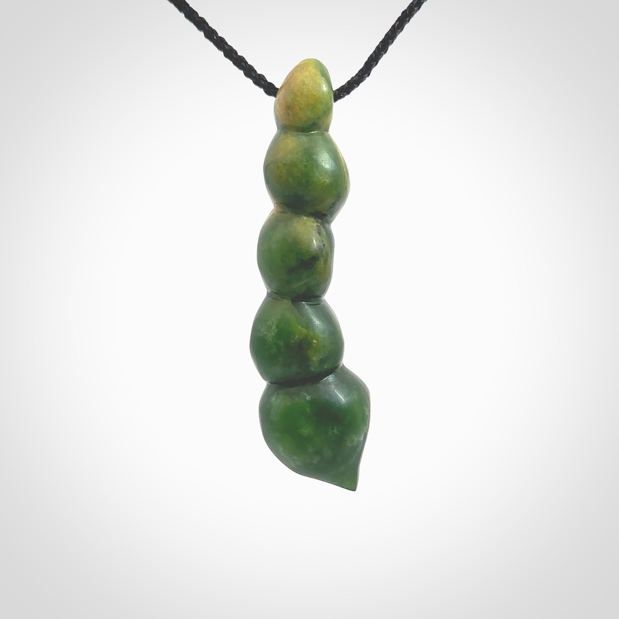 Hand carved New Zealand flower Jade beads drop pendant. Made by Ana Krakosky for NZ Pacific in New Zealand Pounamu, jade. A beautiful orange and green jade beads necklace with black adjustable cord. Large beads necklace carved in flower Jade.