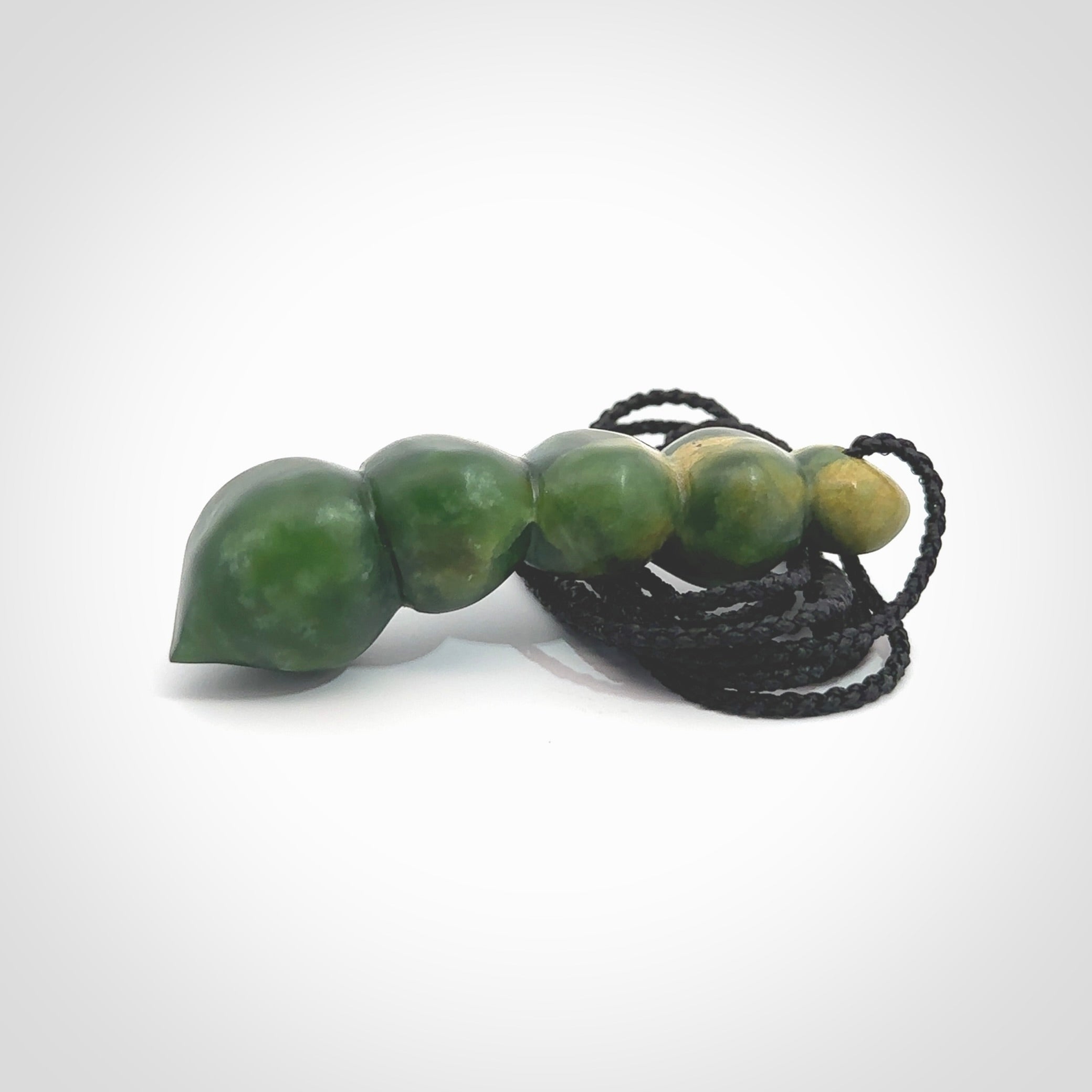 Hand carved New Zealand flower Jade beads drop pendant. Made by Ana Krakosky for NZ Pacific in New Zealand Pounamu, jade. A beautiful orange and green jade beads necklace with black adjustable cord. Large beads necklace carved in flower Jade.