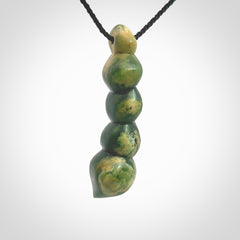 Hand carved New Zealand flower Jade beads drop pendant. Made by Ana Krakosky for NZ Pacific in New Zealand Pounamu, jade. A beautiful orange and green jade beads necklace with black adjustable cord. Large beads necklace carved in flower Jade.