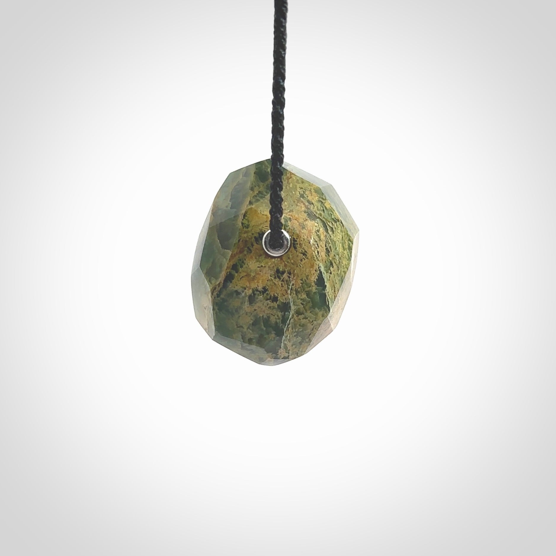 Hand carved large New Zealand flower Jade facet drop pendant. Made by Ana Krakosky for NZ Pacific in New Zealand Pounamu, jade. A beautiful orange and green marsden flower jade large facet drop necklace with black adjustable cord.