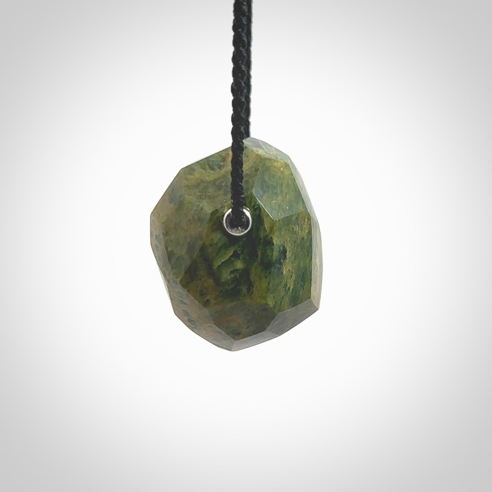 Hand carved large New Zealand flower Jade facet drop pendant. Made by Ana Krakosky for NZ Pacific in New Zealand Pounamu, jade. A beautiful orange and green marsden flower jade large facet drop necklace with black adjustable cord.