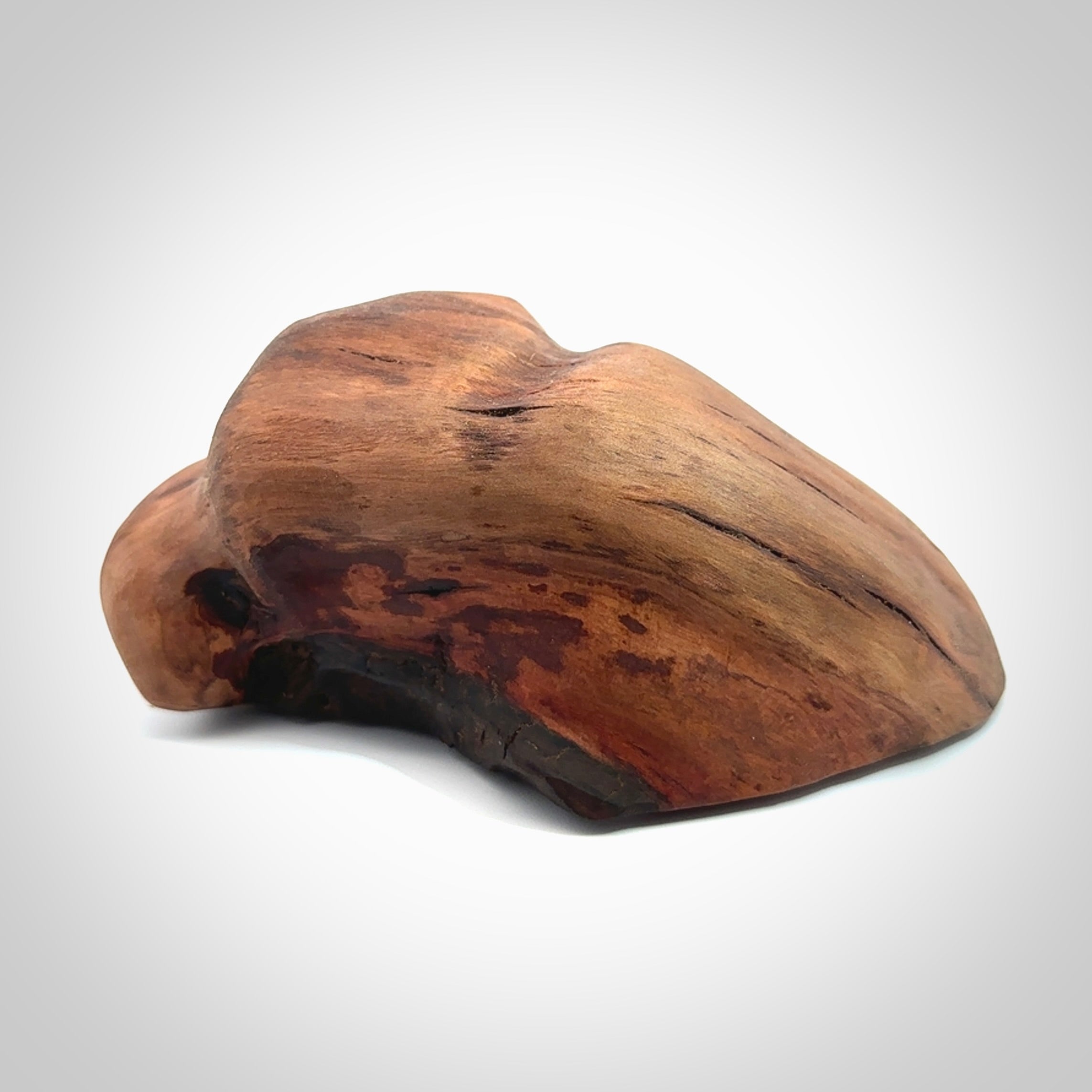 A photo of a New Zealand Jade whale tail in a wave sculpture with Rata Burr stand. This is a statement piece - hand crafted here in New Zealand by Ana Krakosky. Unique Art to display. Gifts for all lovers of hand made sculptures.