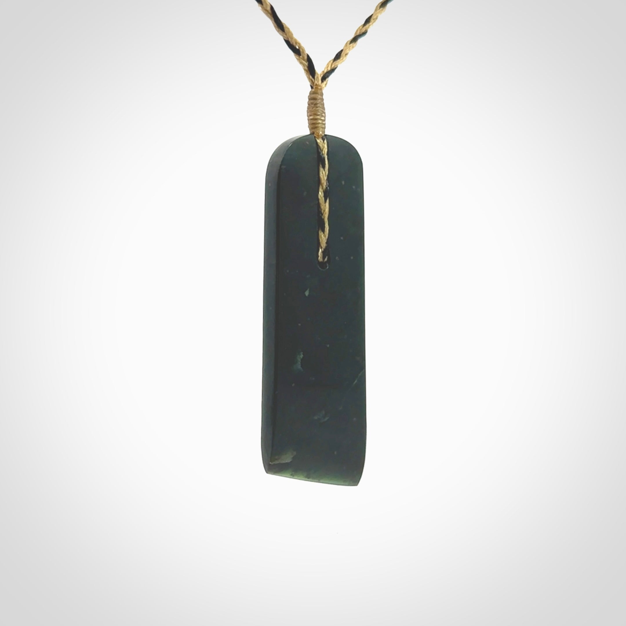 Large New Zealand Tangiwai Pounamu Toki pendant. Hand carved from a lovely piece of local New Zealand Tangiwai Stone. The quality of the workmanship and design is outstanding - this is a piece you will want to wear all the time. We have suspended this from an adjustable 3-plait tan/black cord.