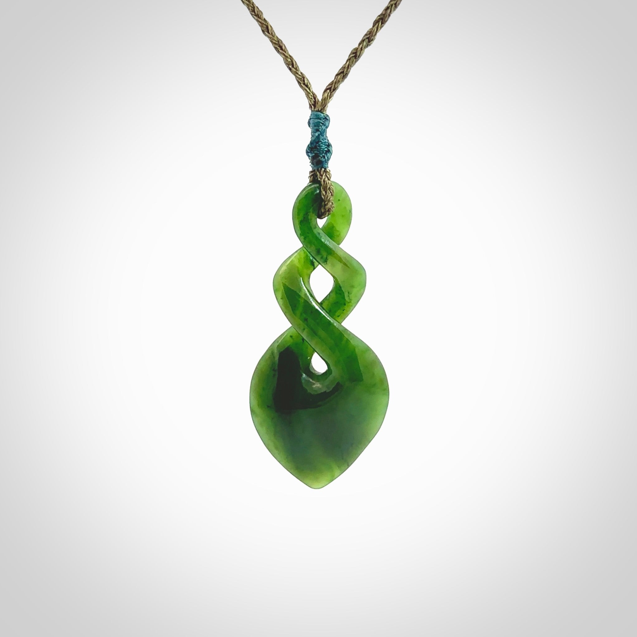 Hand carved New Zealand jade twist pendant. Carved in New Zealand by NZ Pacific. Unique double twist jewellery for sale online. Provided with an adjustable cord.