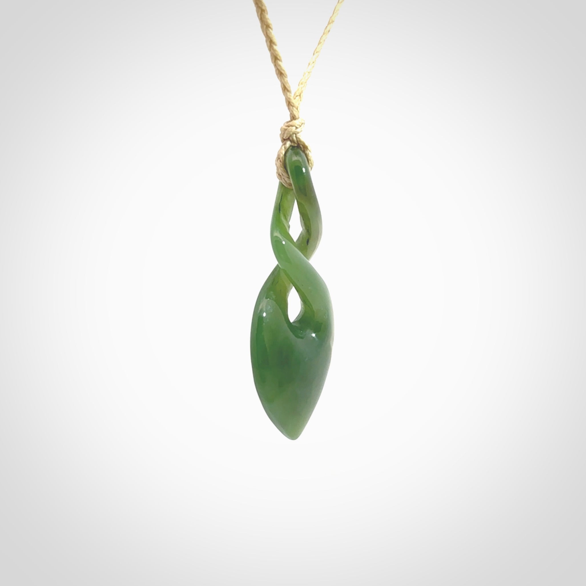 Hand carved New Zealand jade twist pendant. Carved in New Zealand by NZ Pacific. Unique double twist jewellery for sale online. Provided with an adjustable cord.