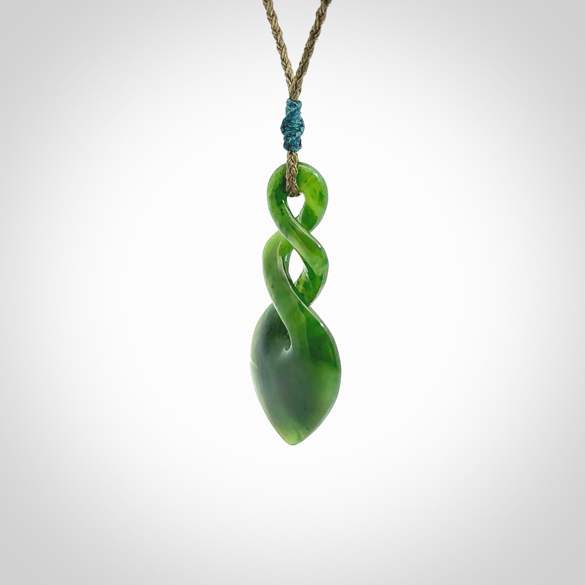 Hand carved New Zealand jade twist pendant. Carved in New Zealand by NZ Pacific. Unique double twist jewellery for sale online. Provided with an adjustable cord.