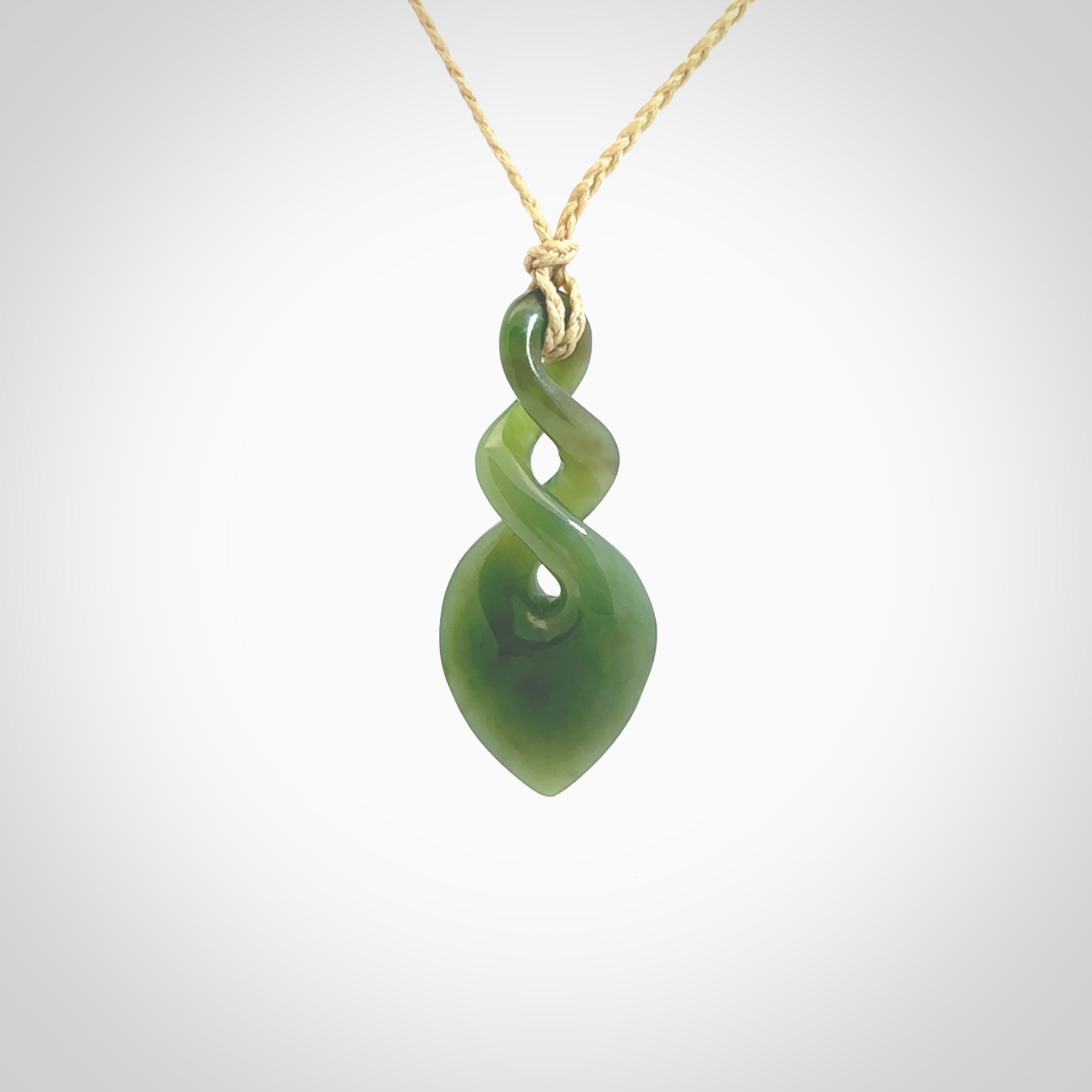 Hand carved New Zealand jade twist pendant. Carved in New Zealand by NZ Pacific. Unique double twist jewellery for sale online. Provided with an adjustable cord.