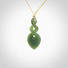 Hand carved New Zealand jade twist pendant. Carved in New Zealand by NZ Pacific. Unique double twist jewellery for sale online. Provided with an adjustable cord.