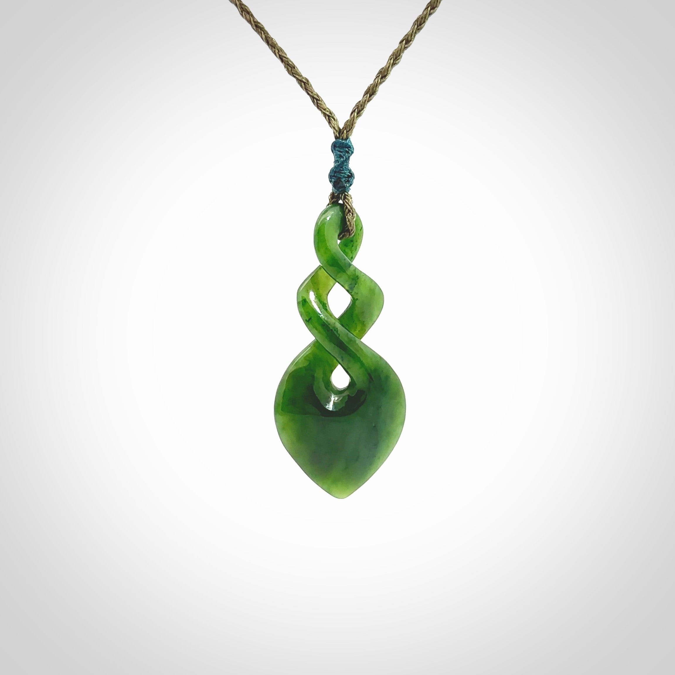 Hand carved New Zealand jade twist pendant. Carved in New Zealand by NZ Pacific. Unique double twist jewellery for sale online. Provided with an adjustable cord.