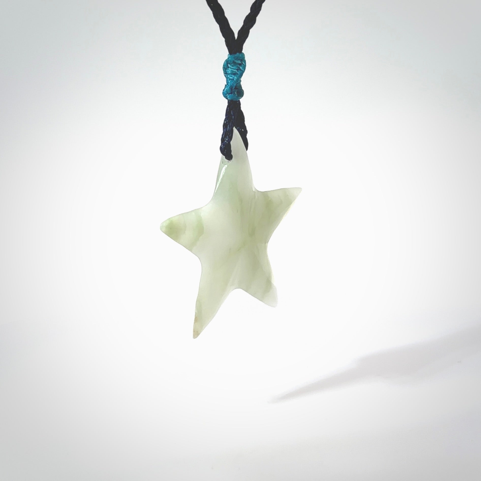 Jadeite star pendant. Star shaped necklace hand made from white Jadeite stone. Delivered on an adjustable blue cord and packaged in a woven kete pouch.