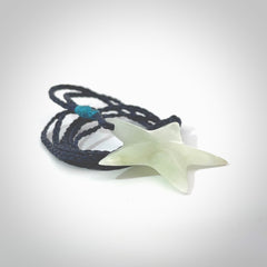 Jadeite star pendant. Star shaped necklace hand made from white Jadeite stone. Delivered on an adjustable blue cord and packaged in a woven kete pouch.