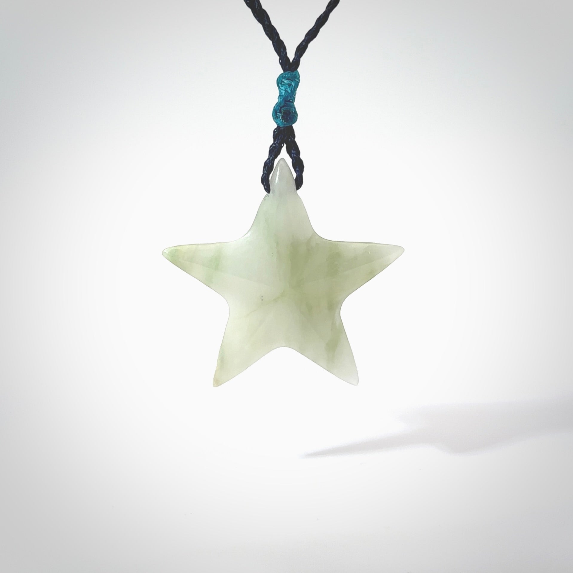 Jadeite star pendant. Star shaped necklace hand made from white Jadeite stone. Delivered on an adjustable blue cord and packaged in a woven kete pouch.