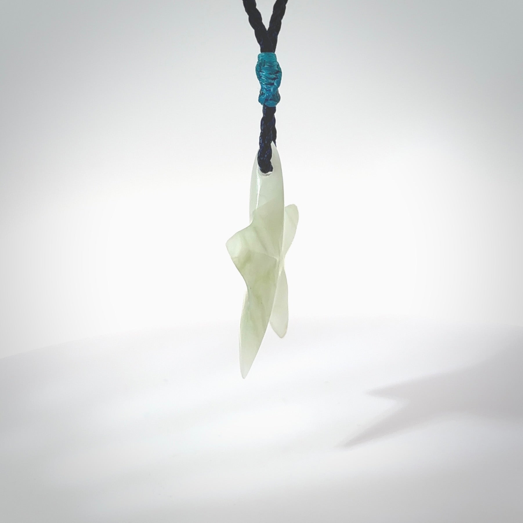 Jadeite star pendant. Star shaped necklace hand made from white Jadeite stone. Delivered on an adjustable blue cord and packaged in a woven kete pouch.