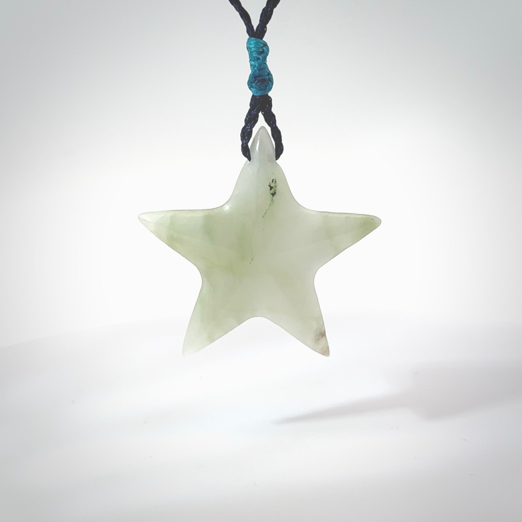 Jadeite star pendant. Star shaped necklace hand made from white Jadeite stone. Delivered on an adjustable blue cord and packaged in a woven kete pouch.