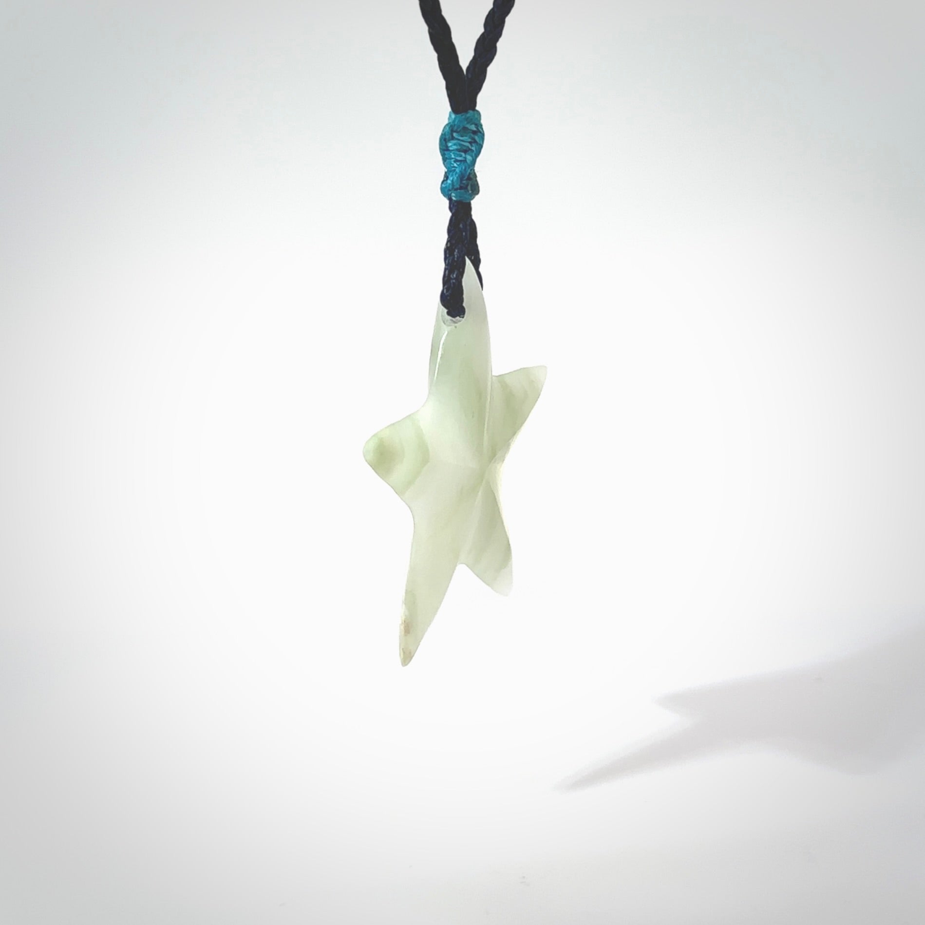 Jadeite star pendant. Star shaped necklace hand made from white Jadeite stone. Delivered on an adjustable blue cord and packaged in a woven kete pouch.